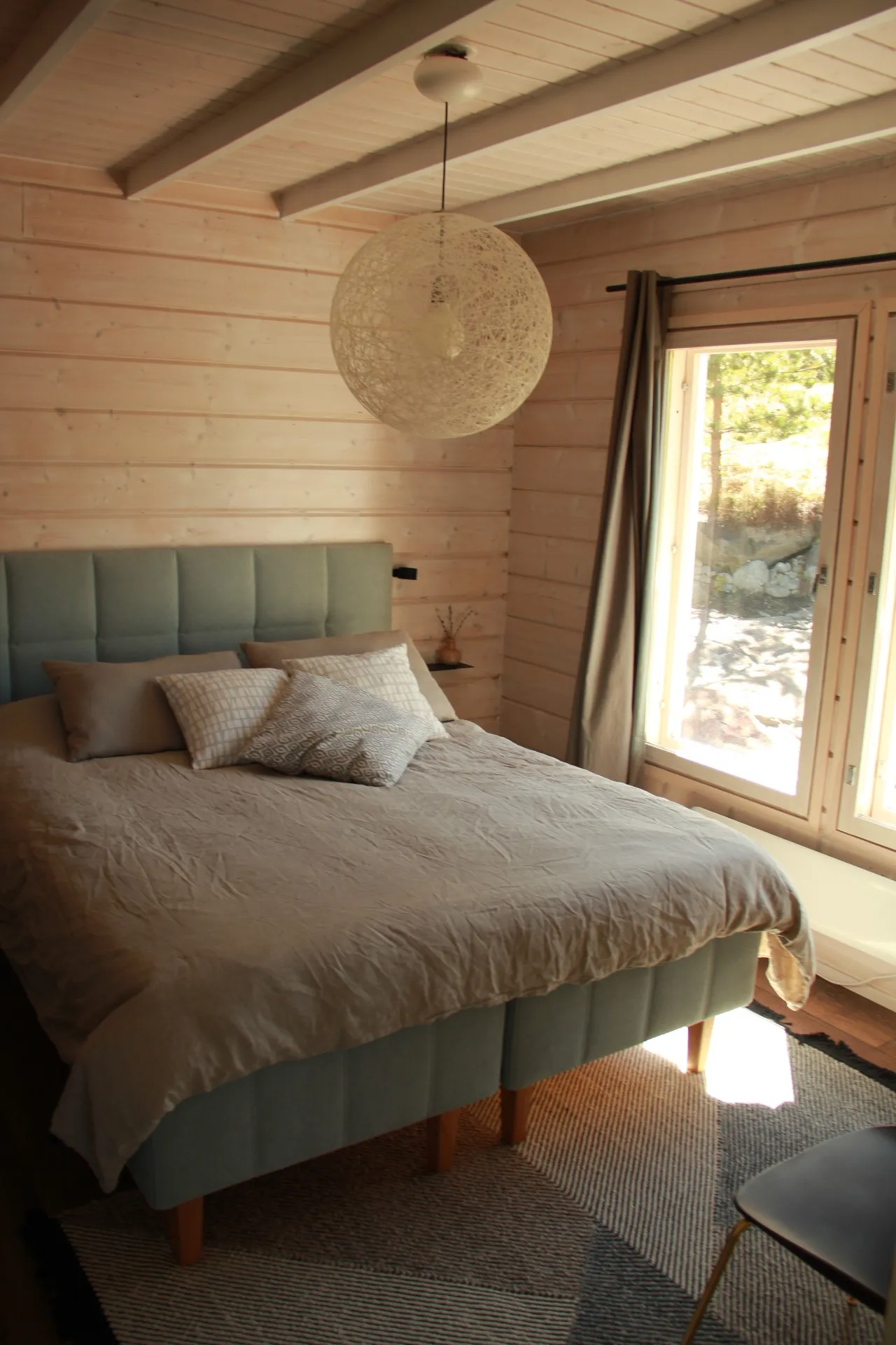 Master bedroom with sage upholstered bed