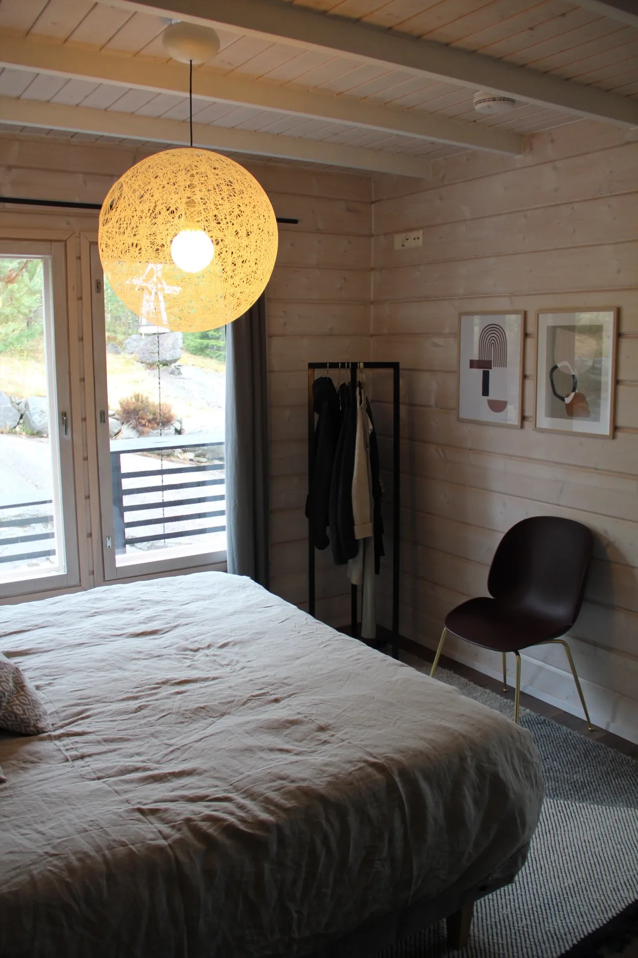 Second bedroom with art prints and reading chair