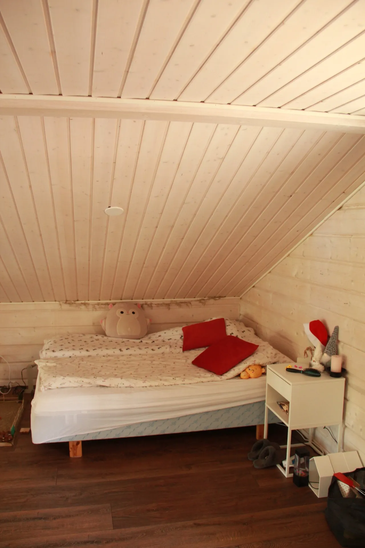 Cozy single bed tucked under the roofline