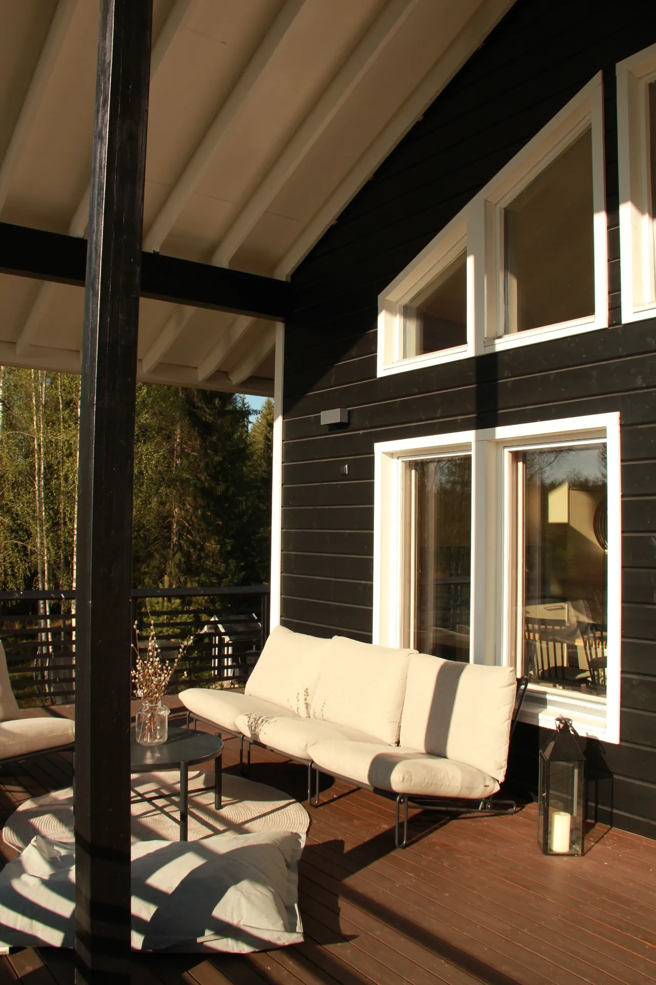 Covered terrace with lounge sofa in evening light