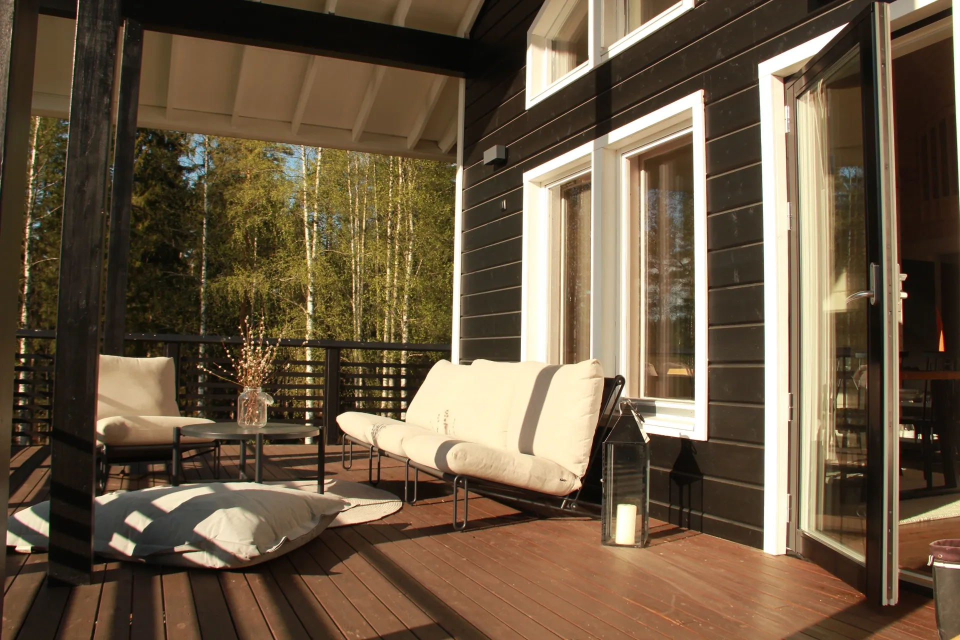 Sunlit terrace with seating and birch trees