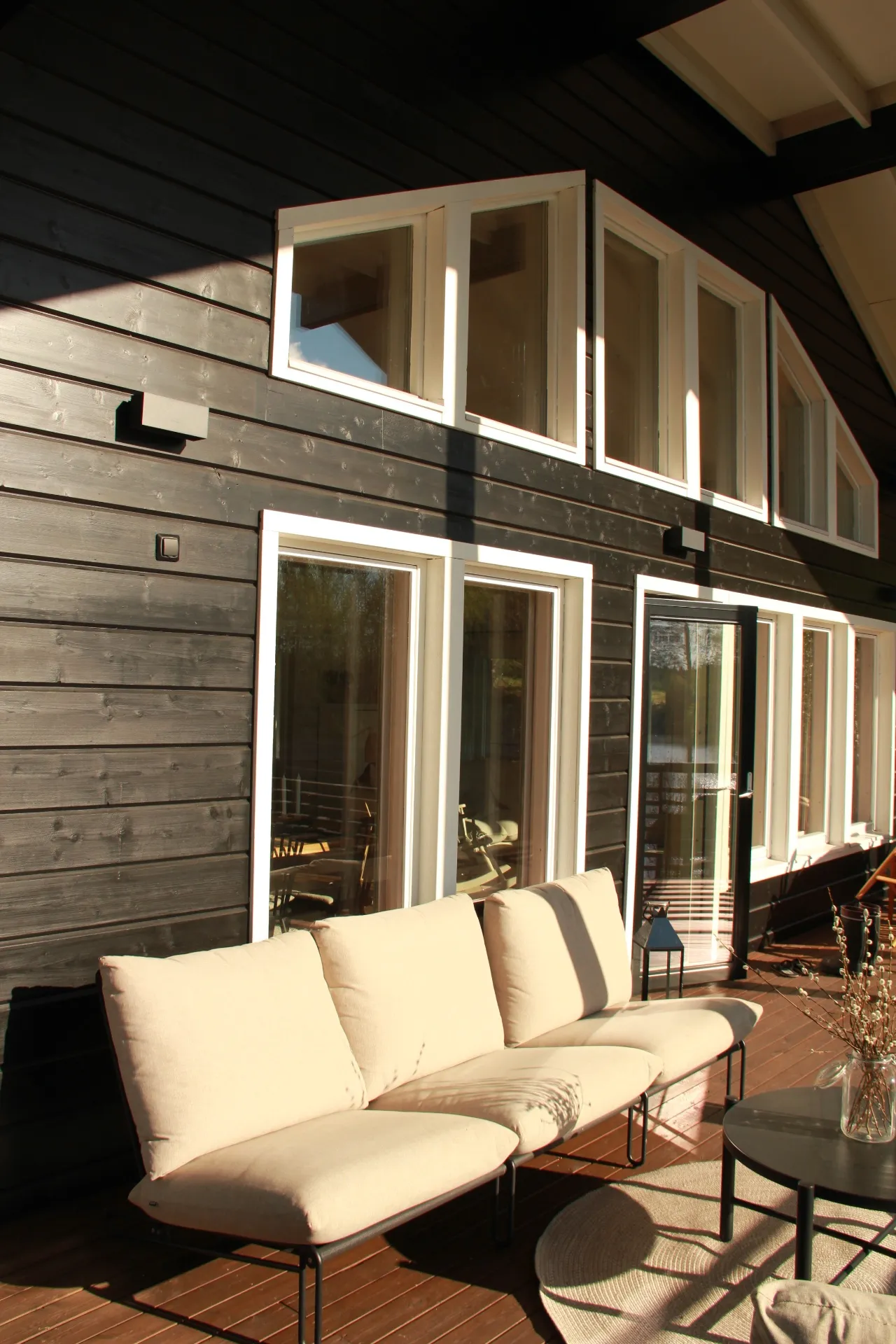 Black timber facade with terrace seating