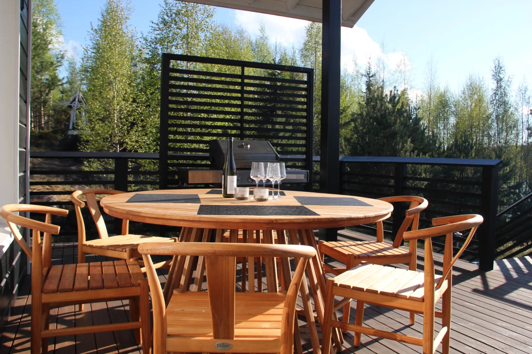 Round teak table and forest view