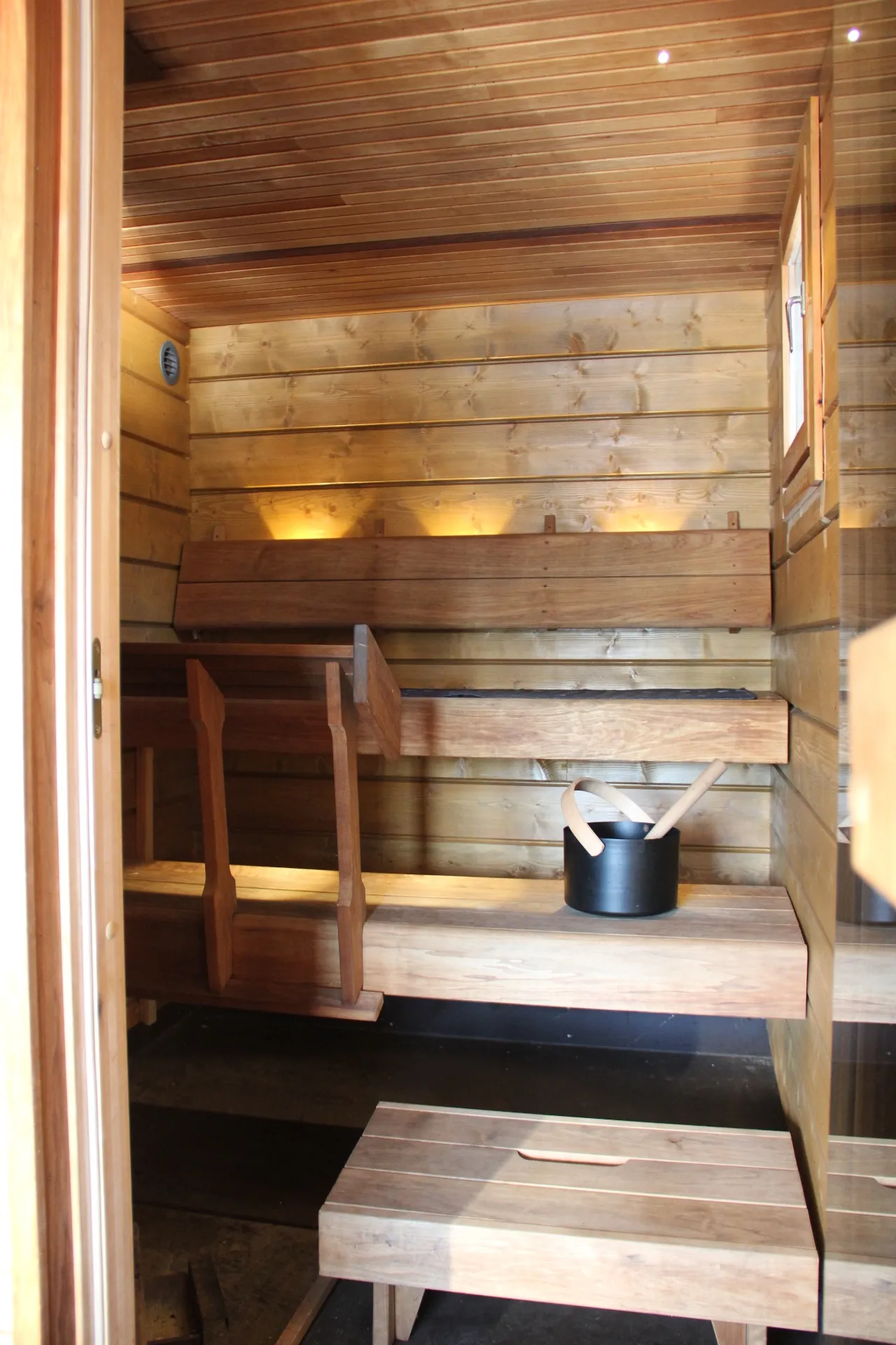 Sauna interior with bucket and ladle