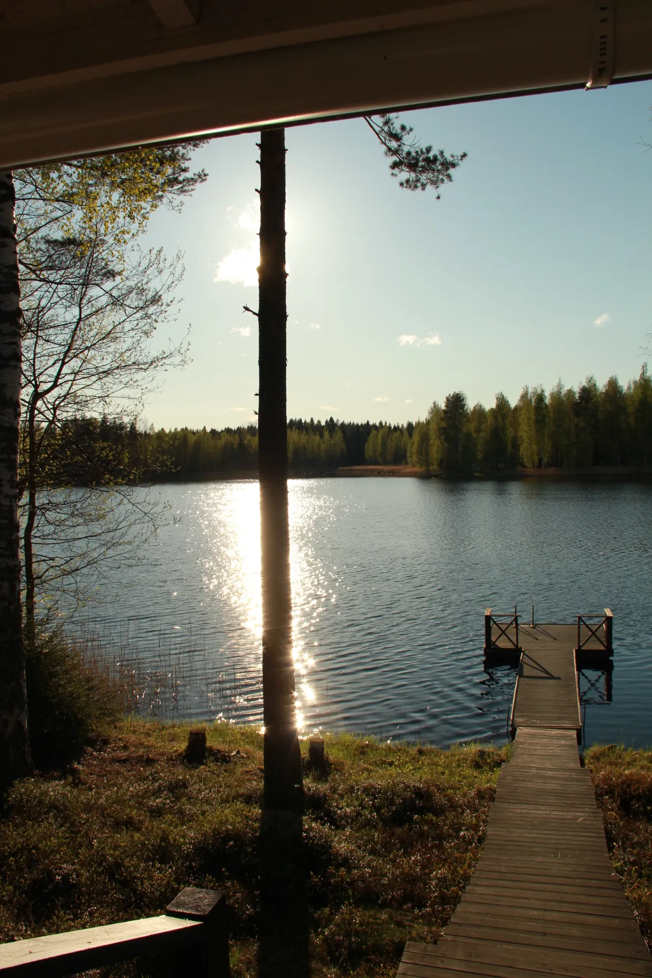 Evening sun glinting on the lake by the dock