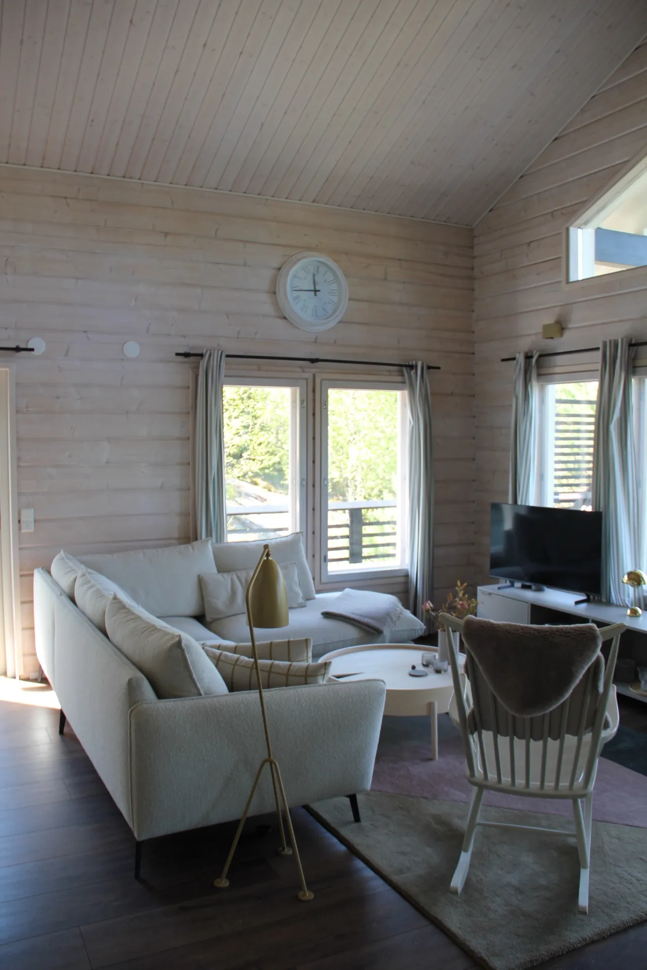 Sofa and rocking chair under vaulted ceiling