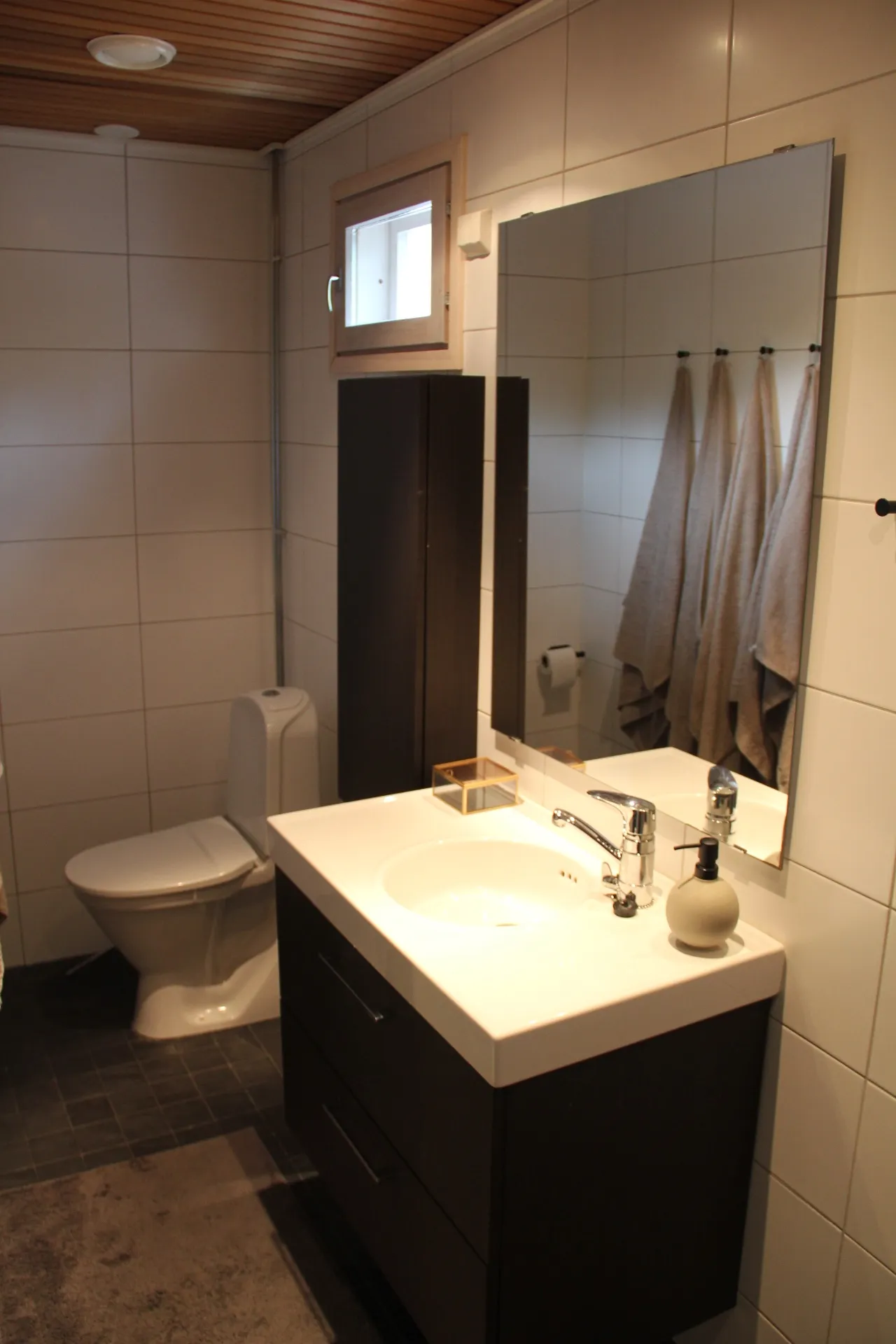 Second bathroom with mirror and storage