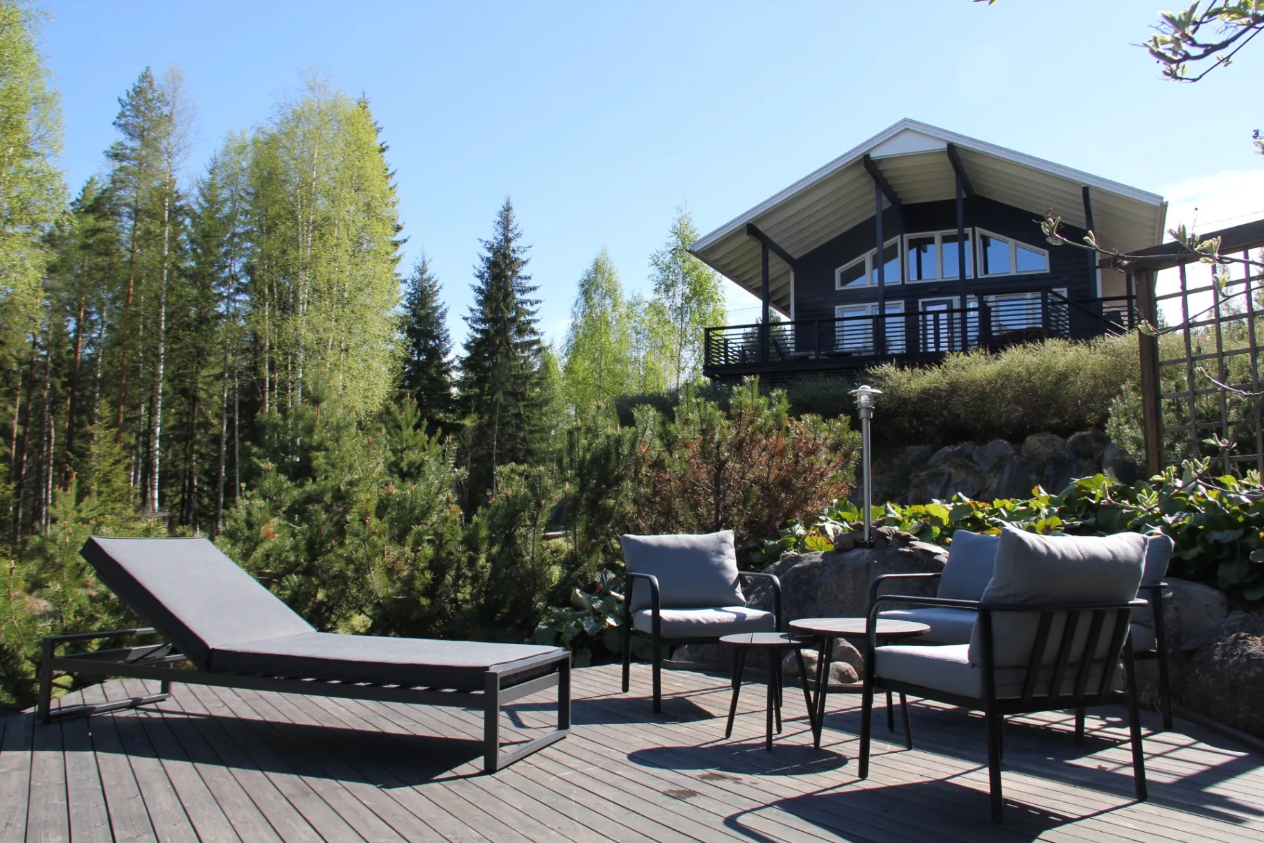 Sun lounger and seating on the deck with forest view